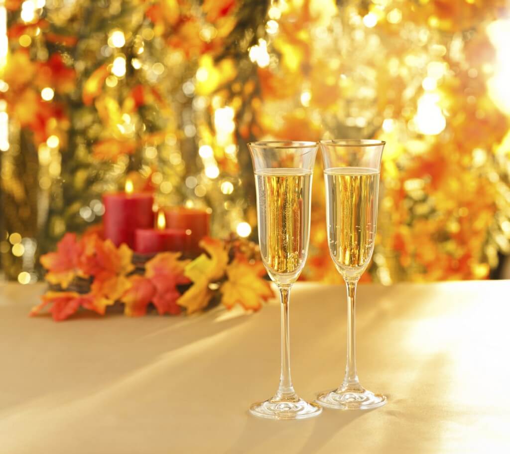 Champagne glasses for reception in front of autumn background