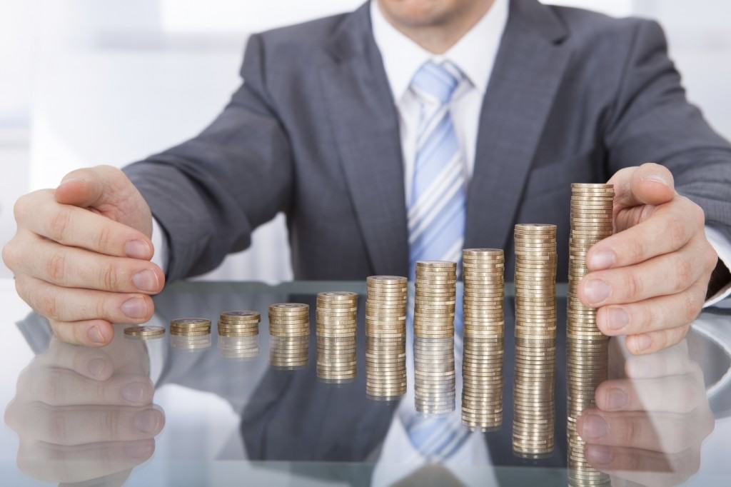 Businessman Protect Stack Of Coins