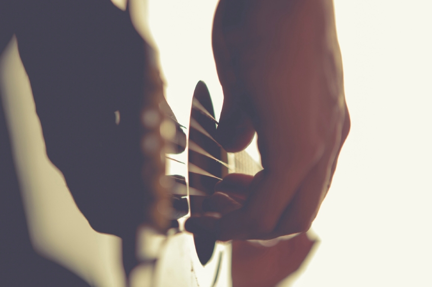 Close up of a man playing the acoustic