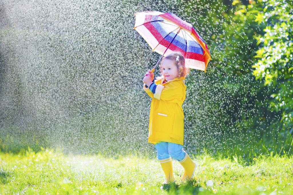 child in rain with umberella