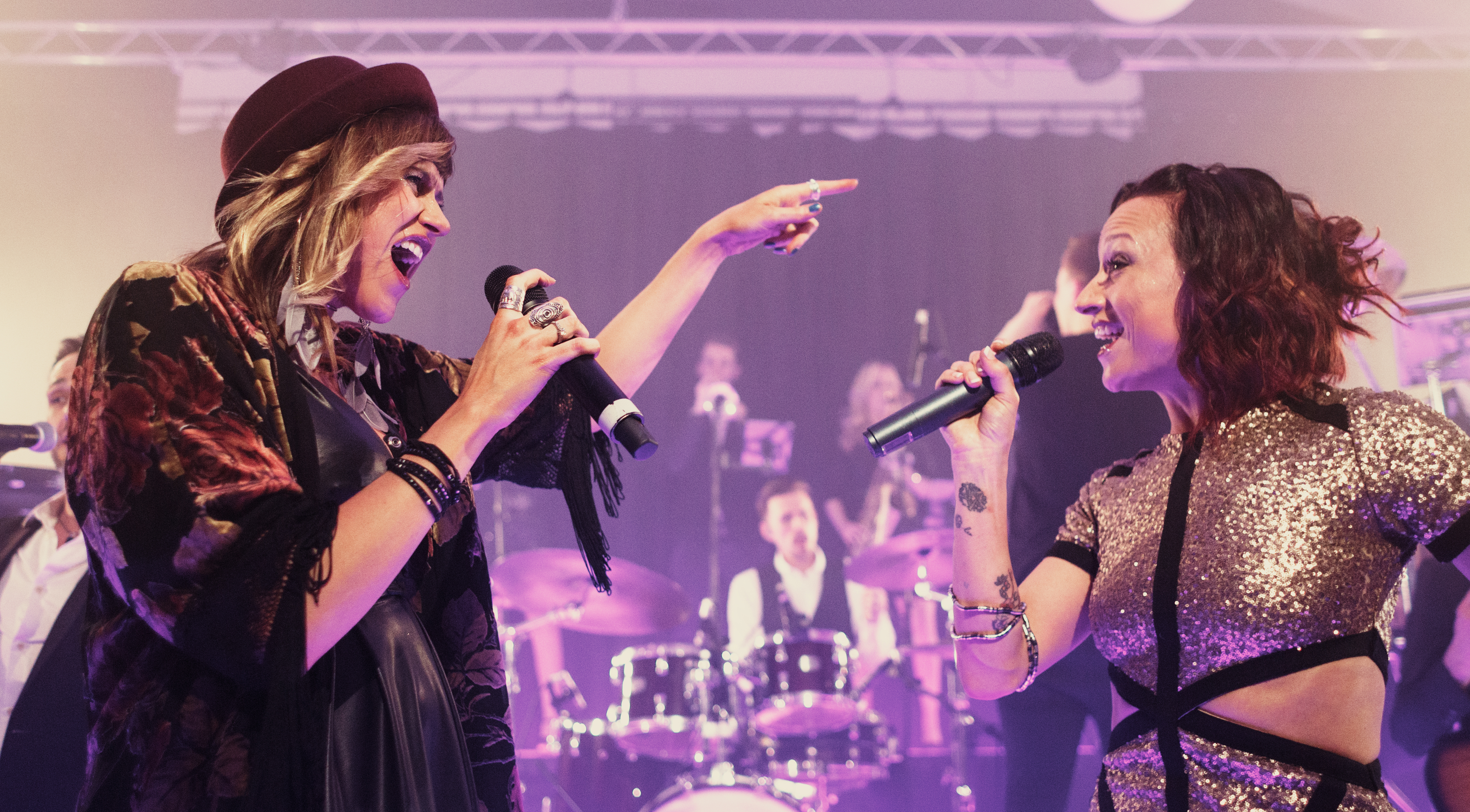 Two female vocalists from The Talent performing duet.