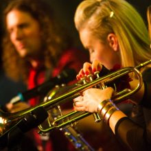 Female performers playing various instruments.